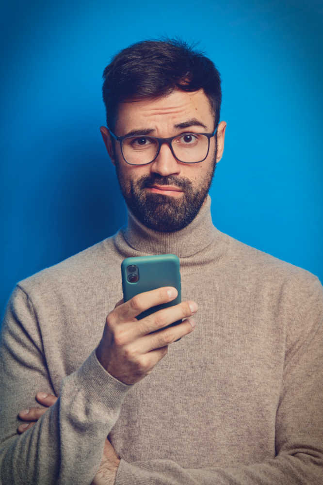 Unhappy man with slow web loading on mobile